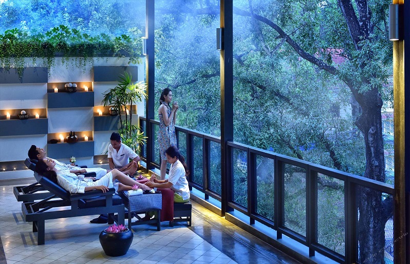 Image of Two people experiencing massage therapy in a beautiful hotel.