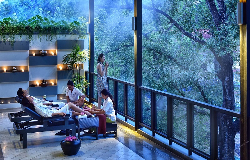 Image of Two people experiencing massage therapy in a beautiful hotel.