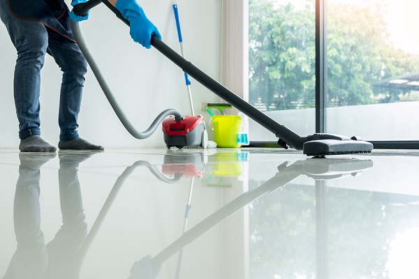 Commercial Cleaner Cleaning Floor With Vacuum Cleaner At Restaurant.