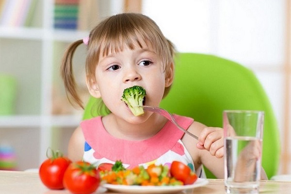 A Beautiful Little Girl Having Healthy Veggies On Her Plate.
