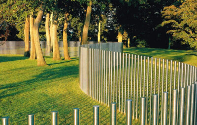 Stainless steel fence in the garden area with trees and greenery atmosphere
