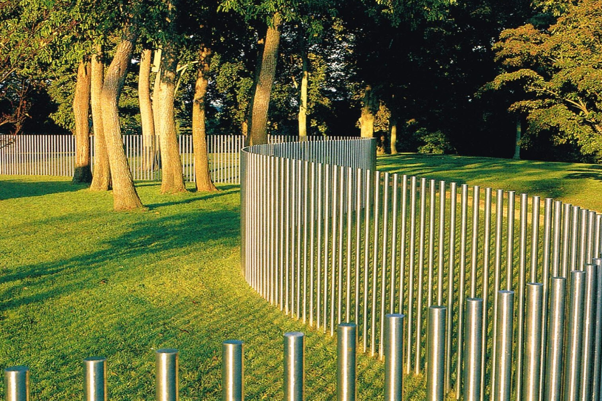 Stainless steel fence in the garden area with trees and greenery atmosphere